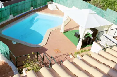 an overhead view of a swimming pool with an umbrella at Wonderful Villa in Albufeira