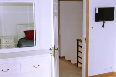 a bedroom with a mirror and a dresser at Wonderful Villa in Albufeira