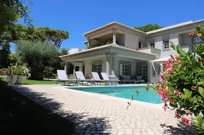 a villa with a swimming pool and a house at Charming Exceptional Golf Villa in Algarve in Faro
