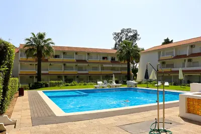 a swimming pool in front of a building at Nautilus 135- Clever Details in Vilamoura