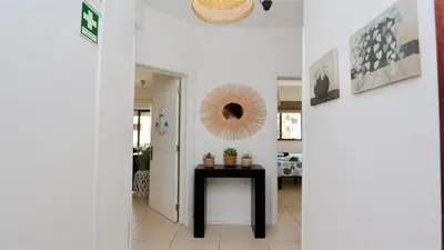 a hallway with a table and a mirror on the wall at Nautilus 135- Clever Details in Vilamoura