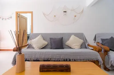 a living room with a couch with pillows on it at Albufeira Centrally Located Apartment with Pool View in Albufeira