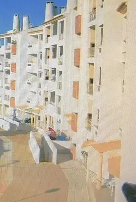a large white building with a table in front of it at Albufeira Centrally Located Apartment with Pool View in Albufeira
