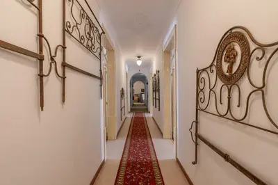 a hallway with a red rug on the floor at Casa dos Arcos - Charm Guesthouse in Albufeira