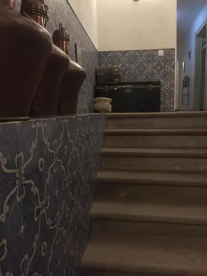a staircase in a building with a patterned wall at Casa dos Arcos - Charm Guesthouse in Albufeira