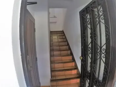 a stairway with a black door and stairs at Vilamoura in Vilamoura