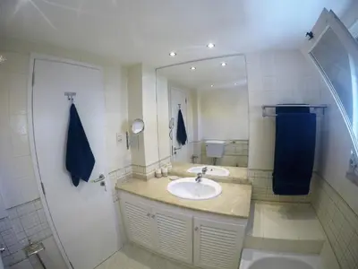 a bathroom with a sink and a mirror at Vilamoura in Vilamoura