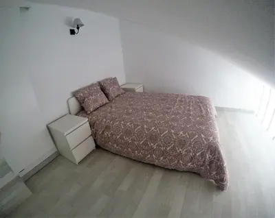 a small bedroom with a bed and a night stand at Vilamoura in Vilamoura