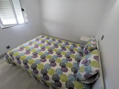 a small bedroom with a bed with a pillow at Vilamoura in Vilamoura