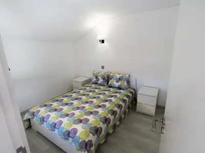 a bedroom with a bed in a white room at Vilamoura in Vilamoura