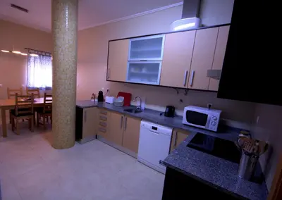a kitchen with a table and a counter top at Apartamentos Plaza - Albufeira in Albufeira