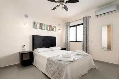 a bedroom with a bed and a ceiling fan at Apartamento Yacintos in Albufeira