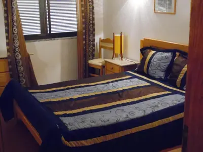 a bedroom with a mirror and a bed at apartamento em albufeira in Albufeira