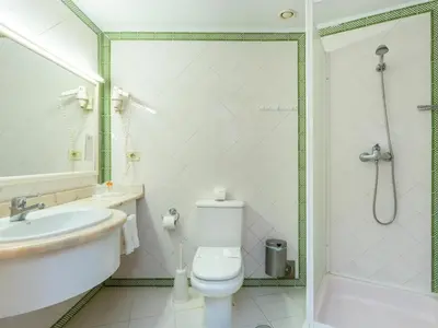 a bathroom with a toilet and a sink and a shower at Tropical Sol in Albufeira