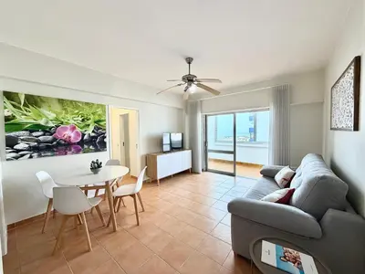 a living room with a couch and a table at Torres Mira Praia by Garvetur in Quarteira