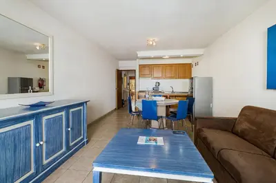 a living room with a couch and a table at Paula Bela by Garvetur in Quarteira