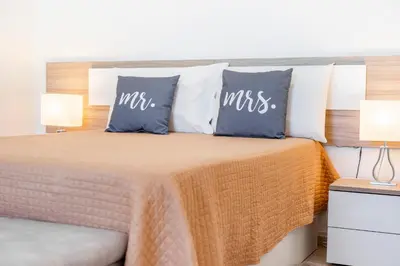 a bedroom with a bed with pillows on it at My Place @ Faro Duplex in Faro