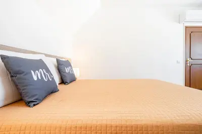 a bedroom with a bed with two pillows on it at My Place @ Faro Duplex in Faro