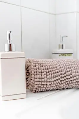 a bathroom with a soap dispenser and a towel at My Place @ Faro Duplex in Faro
