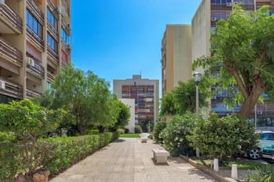 a sidewalk in a city with trees and buildings at FLH Vilamoura Cozy Studio in Vilamoura