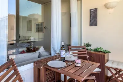 a table with a bottle of wine and two glasses at FLH Vilamoura Cozy Studio in Vilamoura