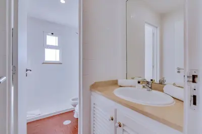 a white bathroom with a sink and a mirror at AL - Apartamento Vista Marina 1 in Vilamoura