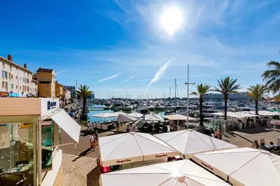 a marina with white umbrellas and a harbor at AL - Apartamento Vista Marina 1 in Vilamoura