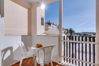 a balcony with a table and chairs and a view of the ocean at AL - Apartamento Vista Marina 1 in Vilamoura