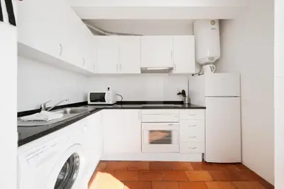 a white kitchen with a sink and a dishwasher at AL - Apartamento Vista Marina 2 in Vilamoura