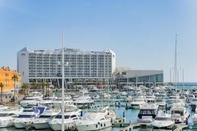 a bunch of boats docked in a harbor with a building at AL - Apartamento Vista Marina 2 in Vilamoura