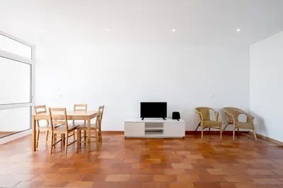 a living room with a table and chairs and a tv at AL - Apartamento Vista Marina 2 in Vilamoura