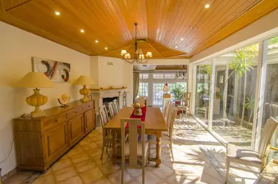 a dining room with a table and chairs and a fireplace at Villa Lira in Almancil