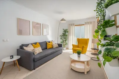 a living room with a gray couch and a yellow chair at #001 Veríssimo Flat by Home Holidays in Albufeira