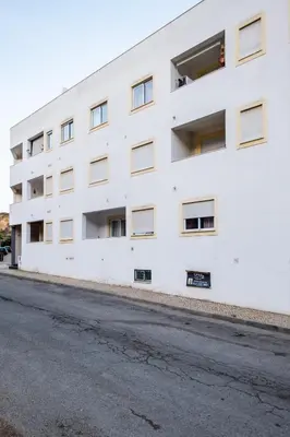 an empty street in front of a white building at #001 Veríssimo Flat by Home Holidays in Albufeira