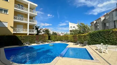 a bedroom with a bed with blue pillows and a window at Garden Hill M by Check-in Portugal in Albufeira