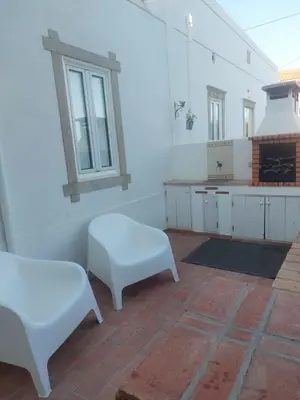 a black cabinet in a room with a tv at Cosy Country House in Cerro da Cova