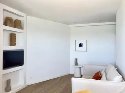 a living room with a couch and a table at Apartamentos Rossio Mar in Albufeira