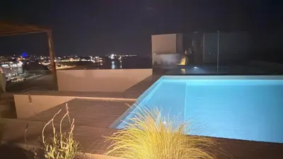 a kitchen with a wooden table with bowls of fruit on it at Apartamentos Rossio Mar in Albufeira