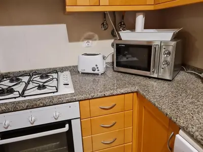 a kitchen with a toaster and a microwave on a counter at Albufeira Monte Balaia in Albufeira