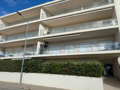 an apartment building with balconies and a street light at Albufeira Monte Balaia in Albufeira