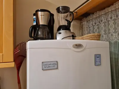 a white refrigerator with two appliances on top of it at Albufeira Monte Balaia in Albufeira