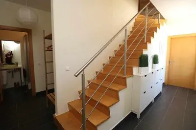 a staircase in a house with wooden floors and a staircase at Hiva T3 By FHR in Vilamoura