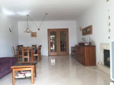 a living room with a purple couch and a table at Moradia Galé in Guia