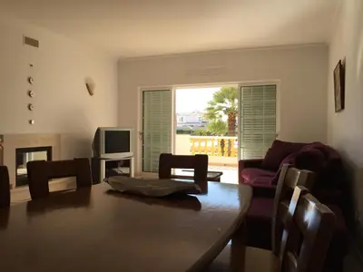 a living room with a table and a couch and a television at Moradia Galé in Guia