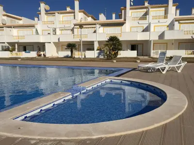 a swimming pool in front of a large building at Moradia Galé in Guia
