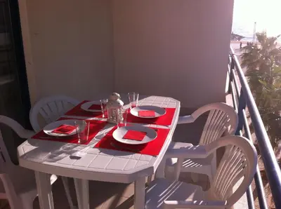 a white table with red napkins and plates on it at Quarteira T1 - Oceanides in Quarteira