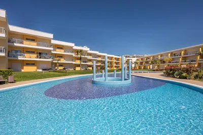 a swimming pool in front of a apartment building at Marina Luxury Residence - Albufeira in Albufeira