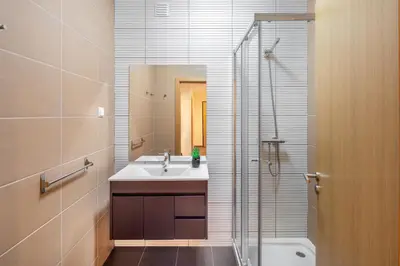 a bathroom with a sink and a shower and a toilet at Marina Luxury Residence - Albufeira in Albufeira