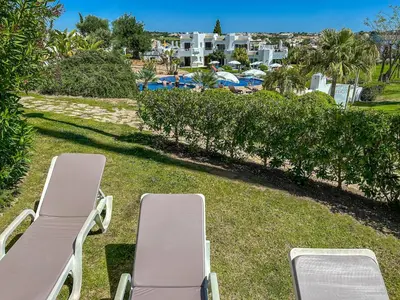 two chaise lounges on the lawn at a resort at Luxury 3 Bedroom Apartment, Albufeira Resort in Albufeira