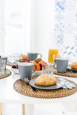 a table topped with plates of food and drinks at Casas Barulho Penthouse Old Town in Albufeira